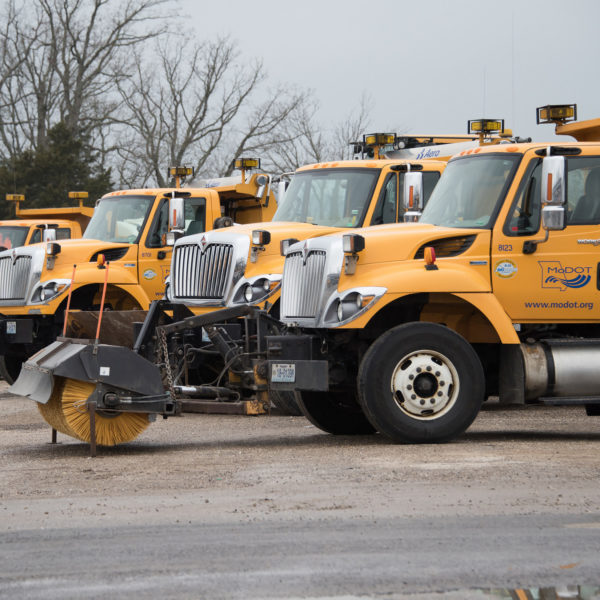 A line of Missouri Department of Transportation trucks parked together