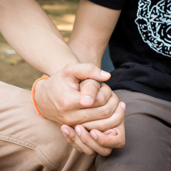 A close up view of two hands clasped together