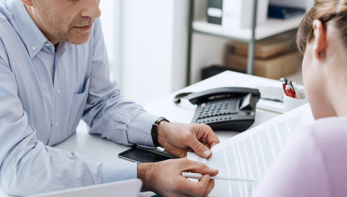 A career counsellor explaining the details of a document to a job seeker