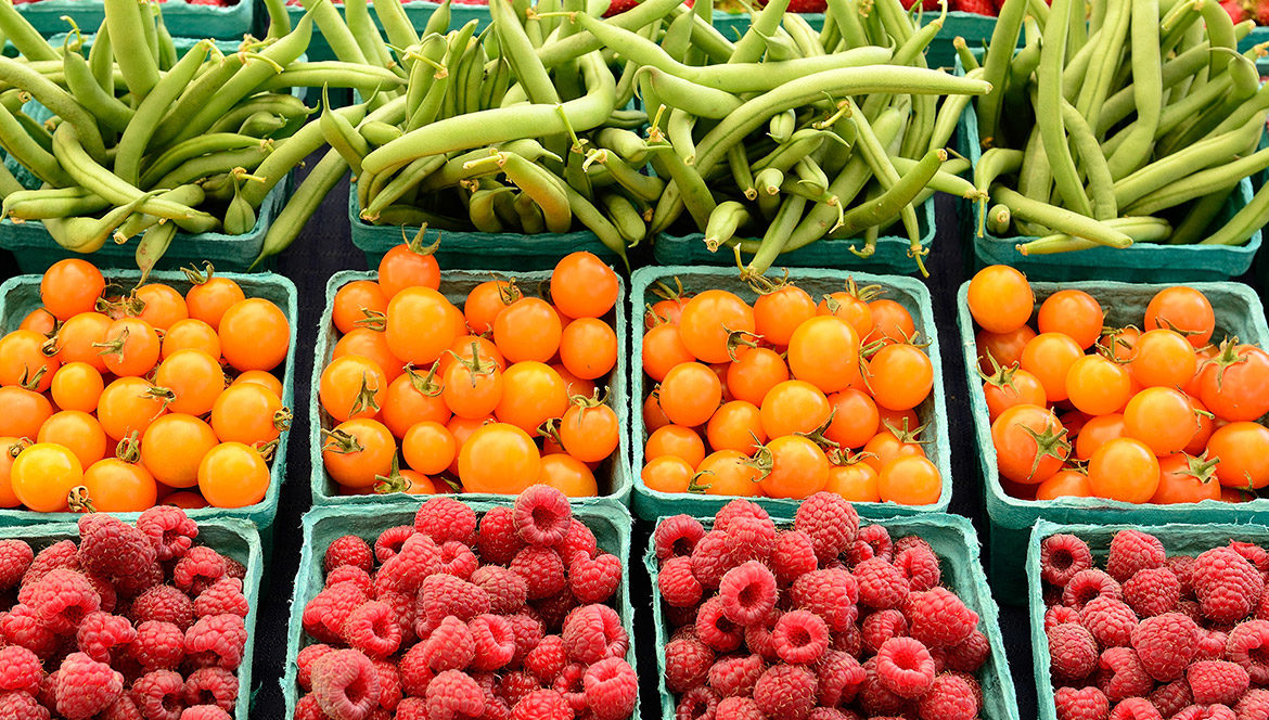 Assorted fruits and vegetables on display in a farmers market