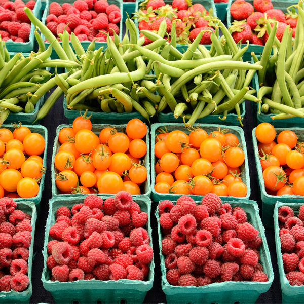 Assorted fruits and vegetables on display in a farmers market