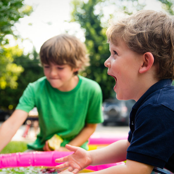 Two young boys playing in a pool