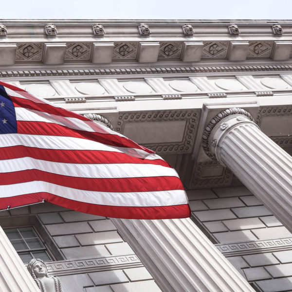 Columns of a courthouse with the US flag