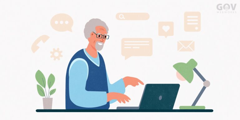 Man with white hair working at a laptop