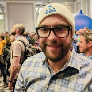 Dries Buytaert at Drupalcon 2026 wearing a Drupal CRM hat.