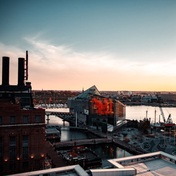 Sunrise over the water near city buildings in Maryland