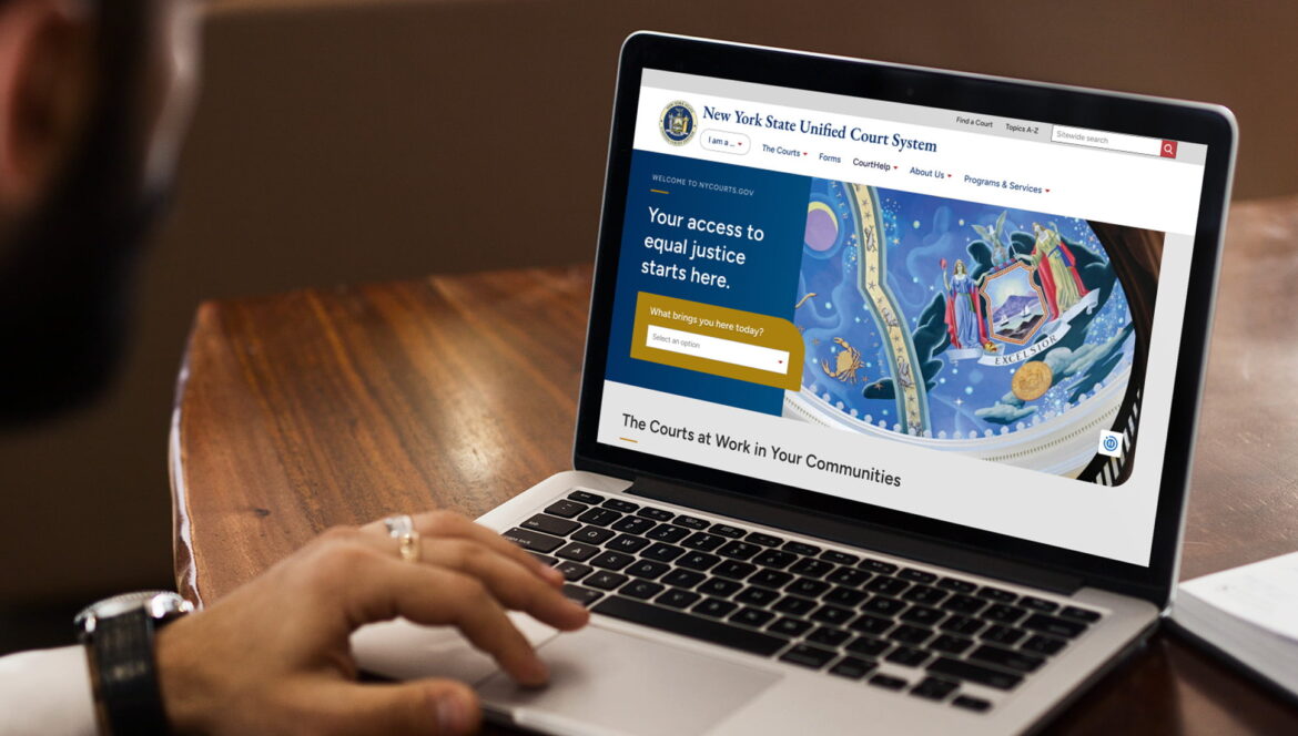 New York State Unified Court System (UCS) website on a laptop