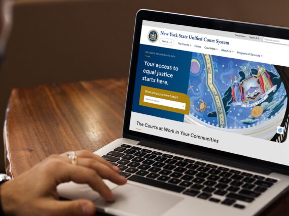 New York State Unified Court System (UCS) website on a laptop