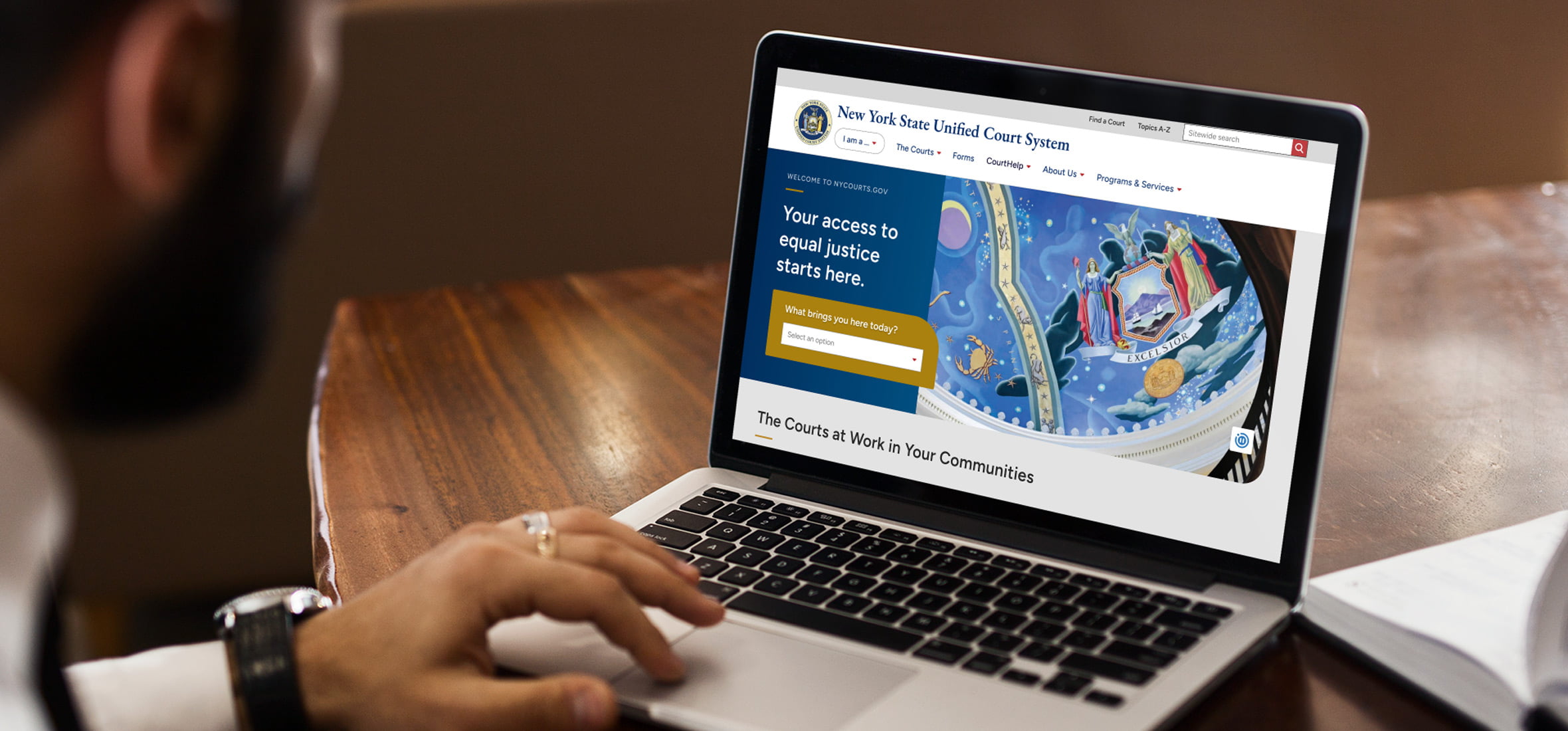 New York State Unified Court System (UCS) website on a laptop