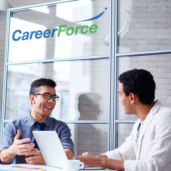 Two people talking next to a laptop with a CareerForce logo above